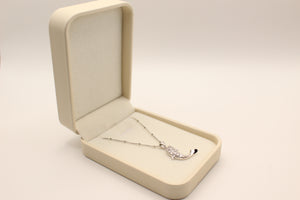 Silver satellite chain with crystal pave dolphin pendant with black tail tip in a cream box